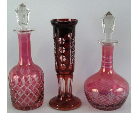 A Bohemian ruby overlay vase, of cylindrical form with slice cut pedestal base and body, 24.5cm high, a cranberry flashed mal