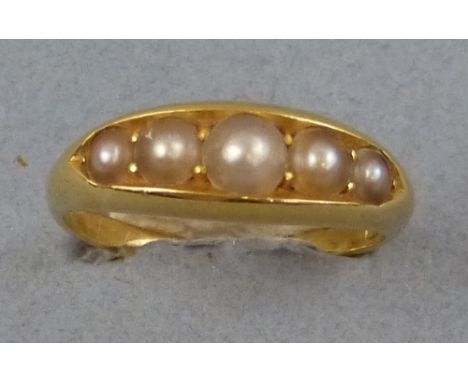 A pearl ring, comprising a line of five channel set graduated split pearls on 18ct gold shank, size M, boxed