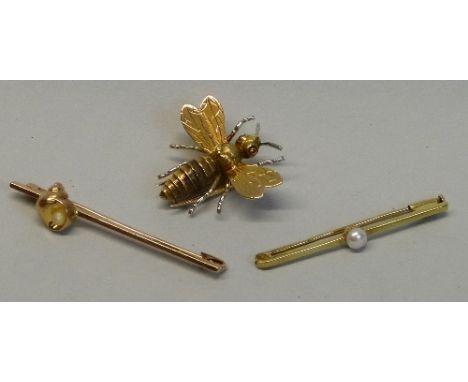 A yellow metal brooch, in the form of a hornet type insect with inset ruby eyes, 3cm long and two pearl mounted bar brooches,