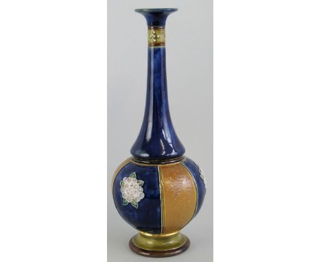 A Royal Doulton stoneware vase, of bottle shaped form with alternate fish scale and flowerhead panels and long slender neck i
