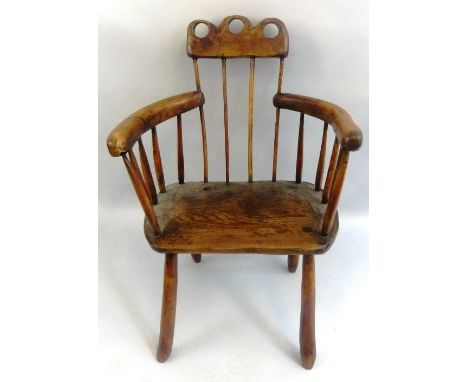A country made yew wood and elm armchair, with arcaded and pierced crest rail over a stick back and sides with curving arm, e