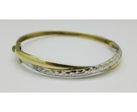 A 9ct two colour gold bangle, 5.9g