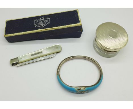 A silver topped bottle, a silver and mother of pearl fruit knife and a white metal and enamelled bangle, a/f, bangle tests as