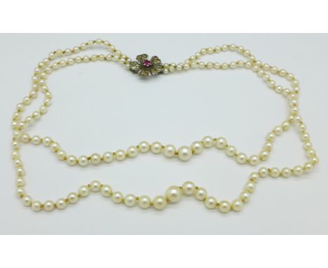 A double strand pearl necklace with silver gem set clasp