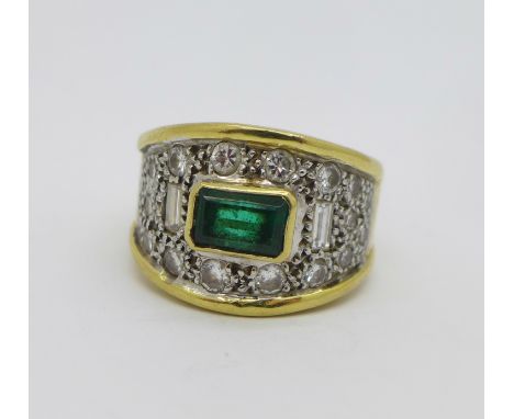 A yellow metal, diamond and emerald ring set with twenty diamonds, two emerald cut, 8.4g, L