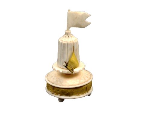 An unusual 19th Century ivory combination tape measure/waxer/pin cushion in the form of a jousting tent, the circular base wi