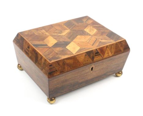 An early 19th Century Tunbridge ware rosewood sewing box of sarcophagal form the lid in cube work with a canted border of van