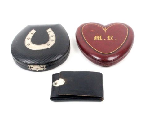 Three late 19th Century small format sewing companions comprising a black leather horseshoe shaped example mounted with a whi