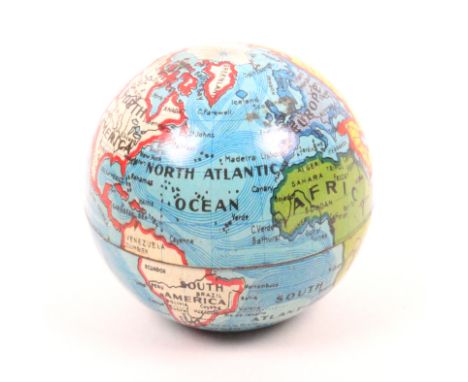 A miniature sewing companion housed in a printed tin globe complete with reels and needlecase, 4.3cm dia