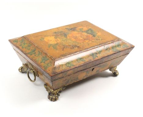 A Regency card or sewing box of sarcophagal form extensively painted with flowers, gilt brass ring handles and elaborate paw 