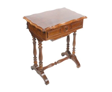 A late 19th Century French walnut sewing table, the hinged rectangular top opening to reveal a re-lined tray over a sliding l