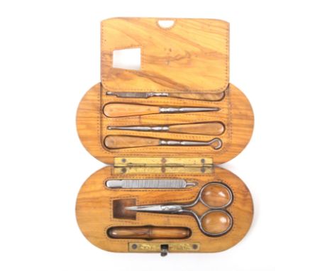 An unusual 19th Century olive wood etui of rounded end rectangular form one side with steel scissors, file and turned wood ne