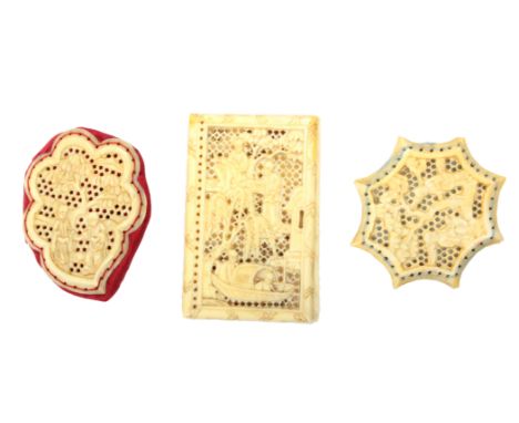 Two 19th Century Chinese export ivory pin cushions and a pair of needle book covers, each pin cushion pierced and carved with