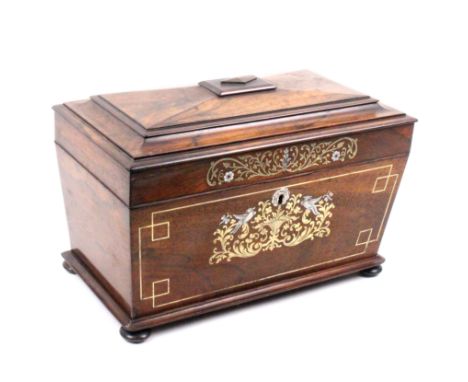 A mid 19th Century rosewood tea caddy of sarcophagal form the front inlaid with cut and engraved brass and mother of pearl wi