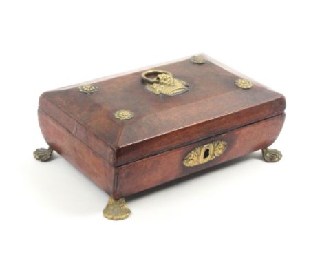 A Regency small format red leather covered sewing box of sarcophagal form, brass mounts and basket of fruit ring handle to li