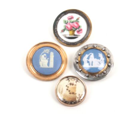 Four late 18th Century/early 19th Century buttons comprising a Wedgwood Jasper ware style example under glass in steel mount 