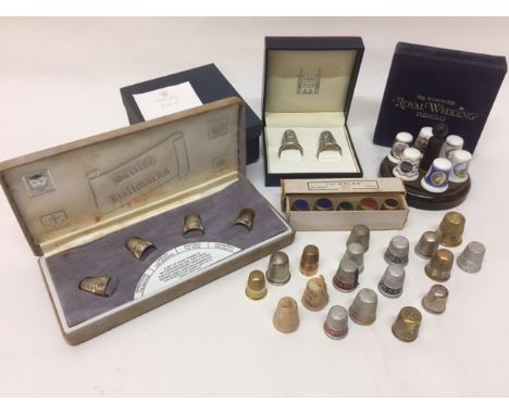 A collection of thimbles comprising a cased pair of silver thimbles issued by The Royal Mint for the 80th birthday of HM The 