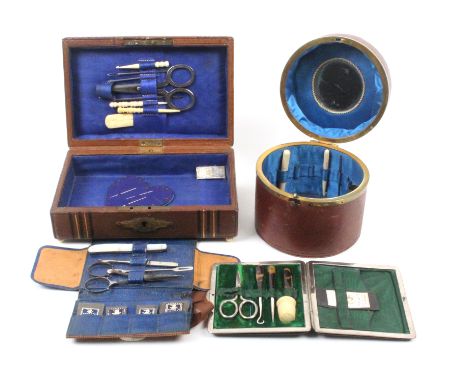 Four late 19th Century small format sewing companions comprising a maroon leather cylinder form example with ring handle, blu