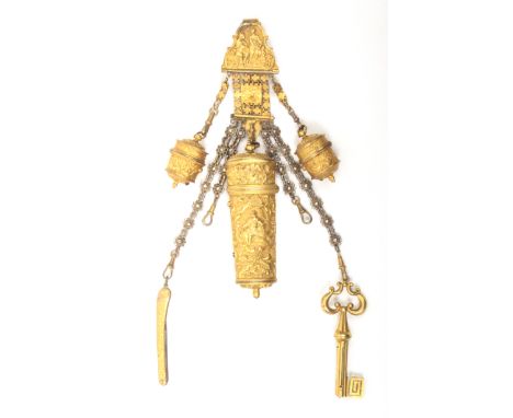 A good early 19th Century gilded metal chatelaine the clip with a scroll mount enclosing figures in a garden with cupid and a