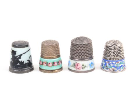 Three continental enamel decorated thimbles and another comprising a silhouette enamel example of a boy fishing, marked to in
