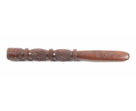 A carved fruitwood 19th Century knitting stick the short paddle blade carved to each side with two birds below two pineapple 