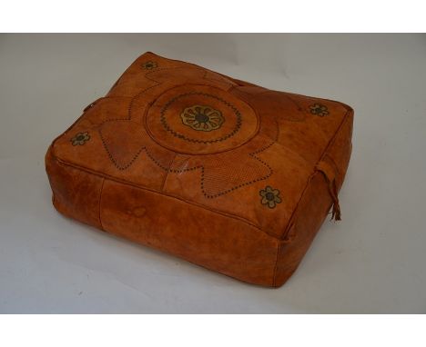 A rectangular leather pouffe