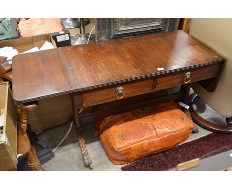 Edwardian mahogany sofa table, two frieze drawers with lion mask ring handles and supports with splayed legs, brass paw caps 