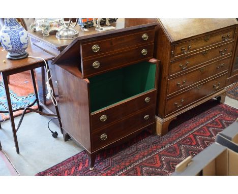 A mahogany commode in the form of a four drawer chest, with dummy fronts lifting to reveal green baize interior