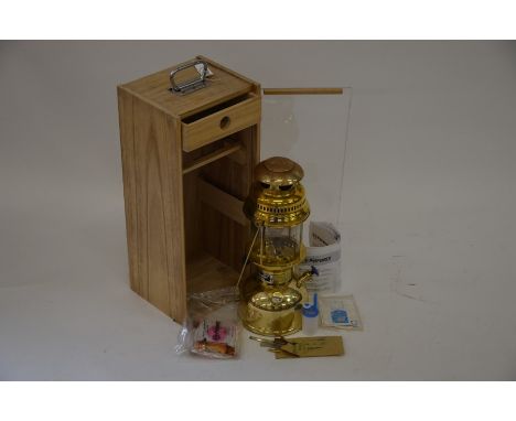 A brass Petromax Rapid Kerosene light in oak and persex case