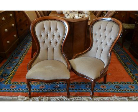 A pair of Victorian style bedroom chairs, mahogany frames with button back light fawn upholstery