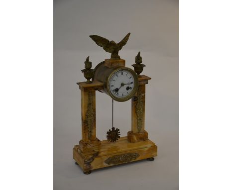A French architectural mantle clock, surmounted by eagle and flaming torches, twin train movement with white enamel dial and 