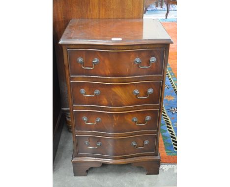 A Georgian style mahogany serpentine front bedside chest, the four drawers with brass swan neck handles, raised on shaped bra