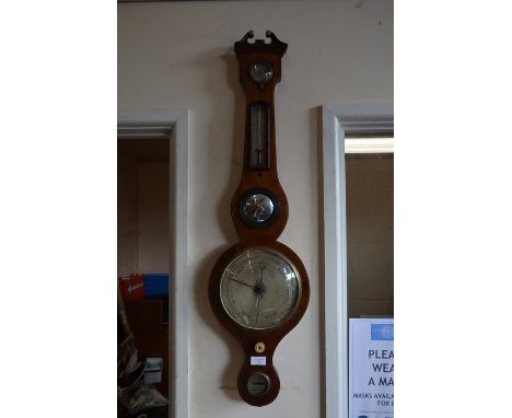 A mahogany wheel barometer/thermometer by W H Moralee of North Shields, with damp/dry gauge and silvered registers, 96 cm hig