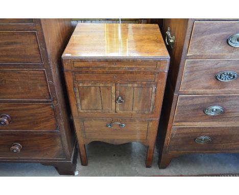 A 19th century mahogany commode with hinged top and two doors over a commode drawer raised on moulded square supports