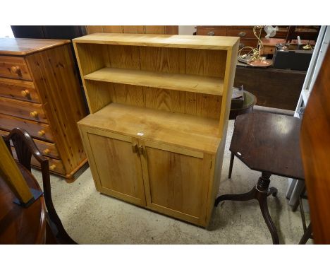 A light oak dresser, the raised back with single open shelf over a pair of panelled cupboard doors