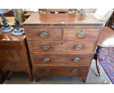 A George III mahogany chest of two short over three long drawers with brass handles, raised on shaped bracket feet (in two se