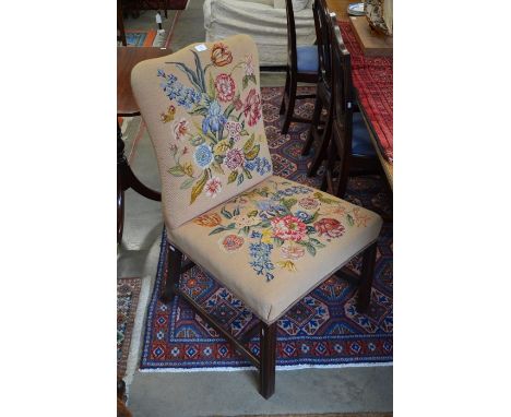 A 19th century mahogany framed side chair with shaped back, floral tapestry upholstery and moulded square supports