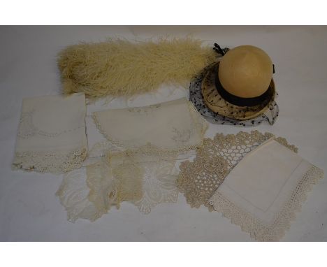 A mixed box to include embroidered tray-cloths and table linen with crocheted edges, an ostrich plume, a 1920s style hat, doi