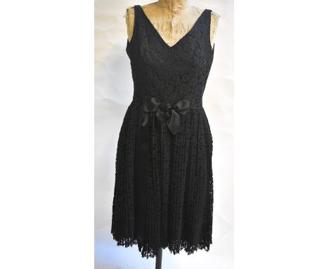 A Frank Usher black lace cocktail dress with pleated skirt and beaded bow detail to waist, 46 cm across chest, and a Frank Us