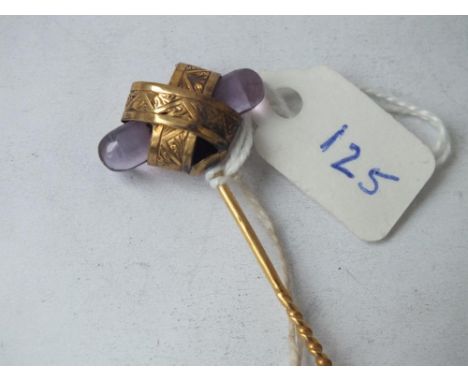 A good Victorian gold stick pin set with cabochon coloured amethyst         