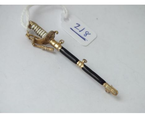 A silver gilt and enamel decorated sword brooch   