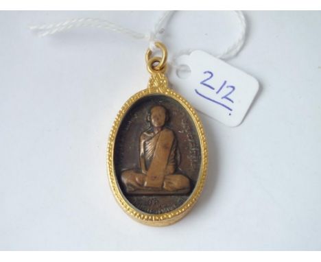 A gold mounted Buddha brooch with bronze centre   