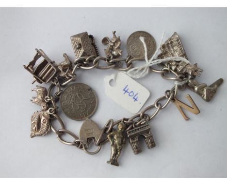 Silver charm bracelet on curb link chain      