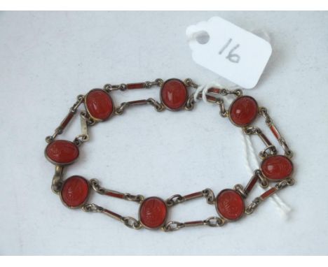 An unusual carved stone and enamel decorated link bracelet set in silver         