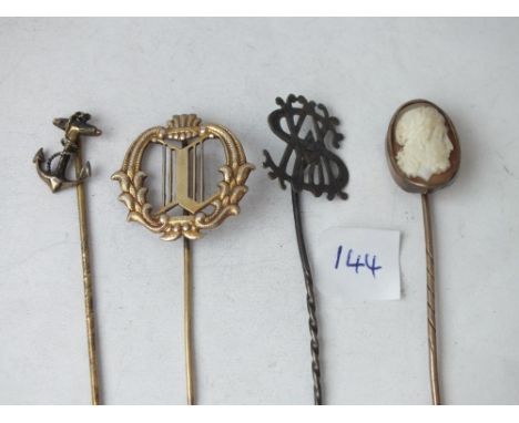 An antique cameo mounted stick pin and three others   