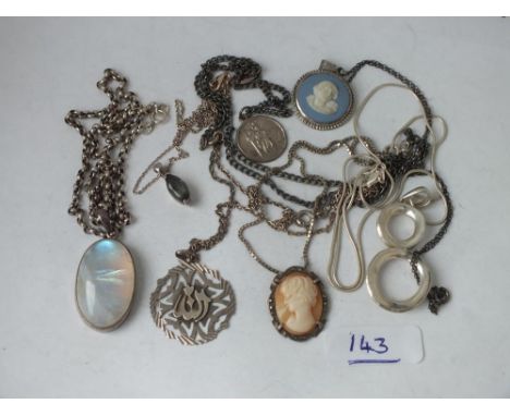 Seven various silver pendants on chains     