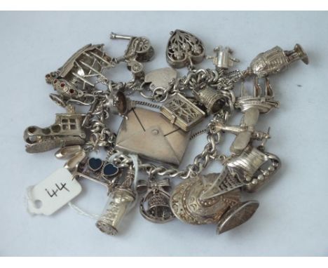 A good silver charm bracelet with stamp envelope etc., 111g  