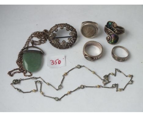 Four silver rings, a brooch etc       