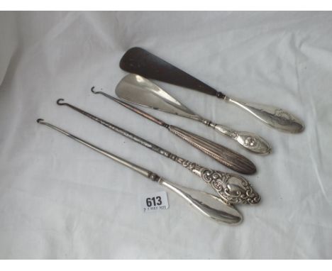 Five various button hooks and shoe horns with silver handles  