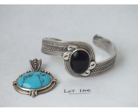 A silver mounted oval pendant and a bracelet    